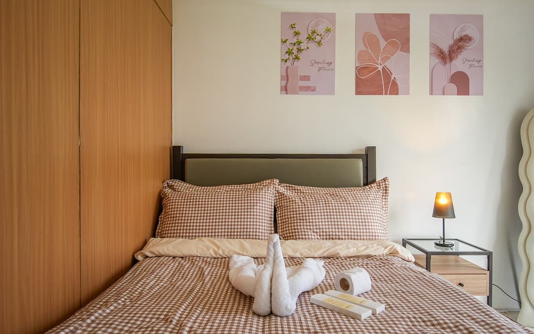 Cozy open-plan studio apartment with warm wood, neutral tones, and sunlight