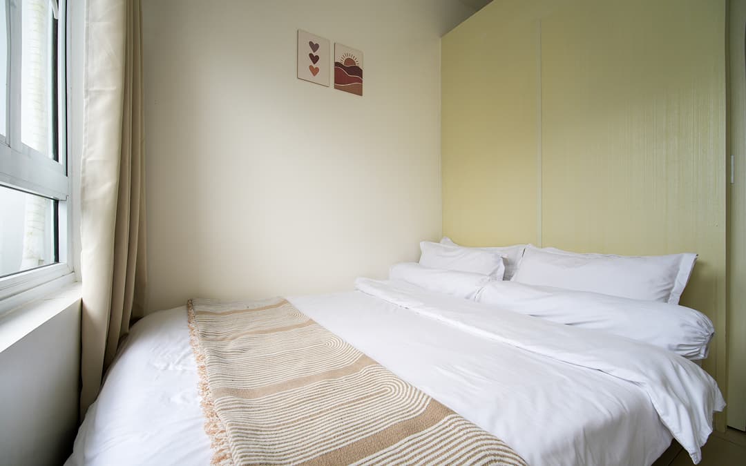 Inviting bedroom with crisp linens, a comfortable bed, and soft natural light